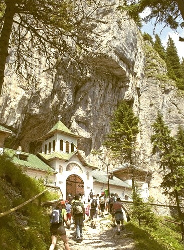 The outside of Pestera Monastery, which has a cave behind it, Romania
